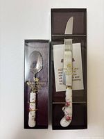 Knife and spoon in open presentation boxes