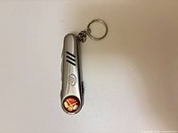 Full view closed showing key ring and emblem