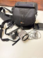Entire lot: camera with lens, strap, Lowepro bag, charger, USB cable