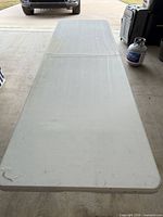 Banquet table unfolded showing full length and surface wear
