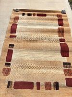 Full rug laid on driveway showing overall design and size