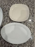 Cream square platter above white oval platter
