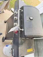 Full view of Dyna-Glo grill with propane tank attached