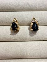 Front view of both earrings showing teardrop design, black cabochons and clear accent stones