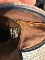 Interior view showing leather lining and size/brand tag
