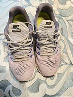 Top view showing uppers, laces, tongue labels, and insoles