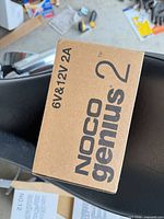 Top of sealed NOCO Genius2 box showing product name and specs