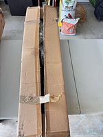 Closed cardboard box containing decorative tree