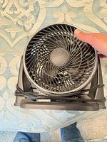 Top view of fan showing spiral grille, blades and attached cord