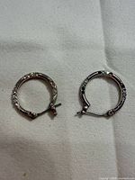 Front of both hoop earrings showing stone accents and closures