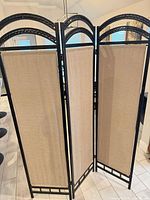 Full view of three-panel divider displaying arches and fabric