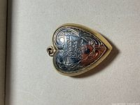 front view showing engraved inscription and two-tone design