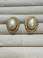 front view of both earrings showing faux pearls and ornate gold-tone frames