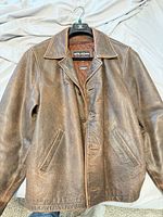 Front view showing button closure, pockets, collar and overall leather condition