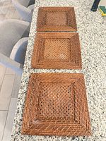 All three square woven rattan trays on countertop