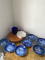 Overall lot view: five blue plates, cobalt vase, cornflower casserole