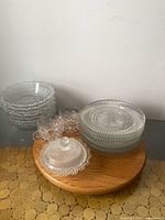 Group shot of plates, bowls and sugar bowl on wooden board