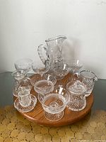 Group view showing all crystal pieces including coupes, pitcher and serving items