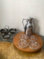 Lot overview showing chrome carafe, acrylic egg cups, metal condiment caddy