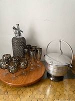 Full lot showing seltzer bottle, 10 silver fade glasses on a wooden tray, and aluminum ice bucket