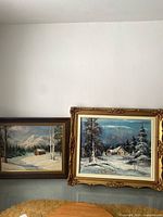 Both framed paintings side by side