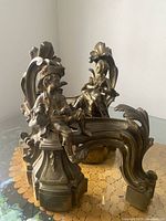 Both patinated brass andirons front view