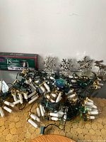 Overview of tangled candle light strands, stocking holders and box