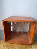 Front view of wooden cube caddy showing hanging stemware