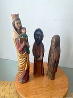 Front view of all three wood carved statues