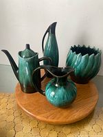 All four turquoise drip glaze pieces on wood stand