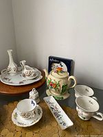 Group shot of Aynsley Cottage Garden china pieces, teapot, Baileys mugs