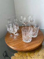 All ten crystal pieces grouped on a round wooden stand