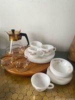 Full lot showing plates, bowls, cups, saucers, decanter, creamer, sugar bowl