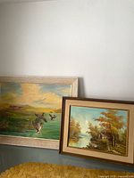 Front view of both framed landscape paintings