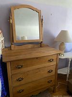 Front view showing dresser, three drawers, mirror, hardware