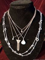 All five necklaces displayed on bust