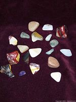 Group view of all polished stones on maroon background