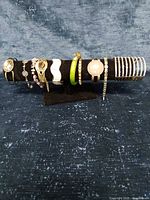 All ten bracelets displayed on black velvet stand