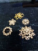Front view showing all five brooches