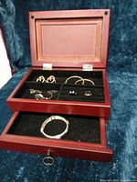 open jewelry box showing interior compartments and contents
