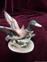 Left side view of porcelain mallard duck figurine on base