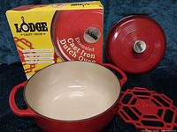 Dutch oven, lid, trivet and original box displayed