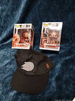 Lot overview showing two Funko POP! boxes and Giants cap