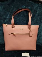 Front view of Coach taffy pink tote showing overall design and size