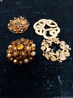 Group view of all four brooches
