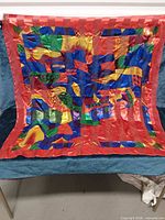 Red multicolour abstract square scarf displayed