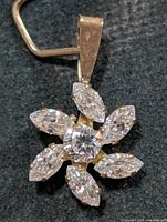 Front view of 10K gold cubic zirconia flower pendant