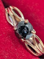 Front view of gold ring with black diamond