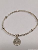 Bracelet full view showing bead and tube design with Dream charm