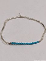 Full view of bracelet showing turquoise and silver-tone beads